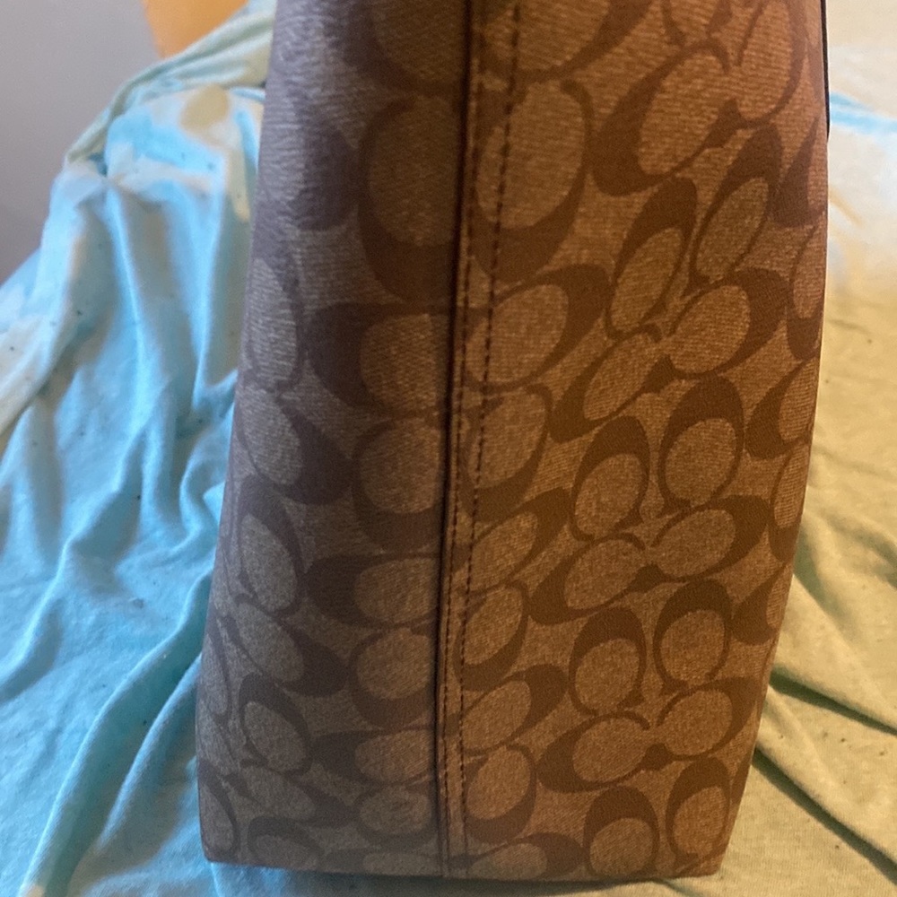 A coach bag brown and tan
